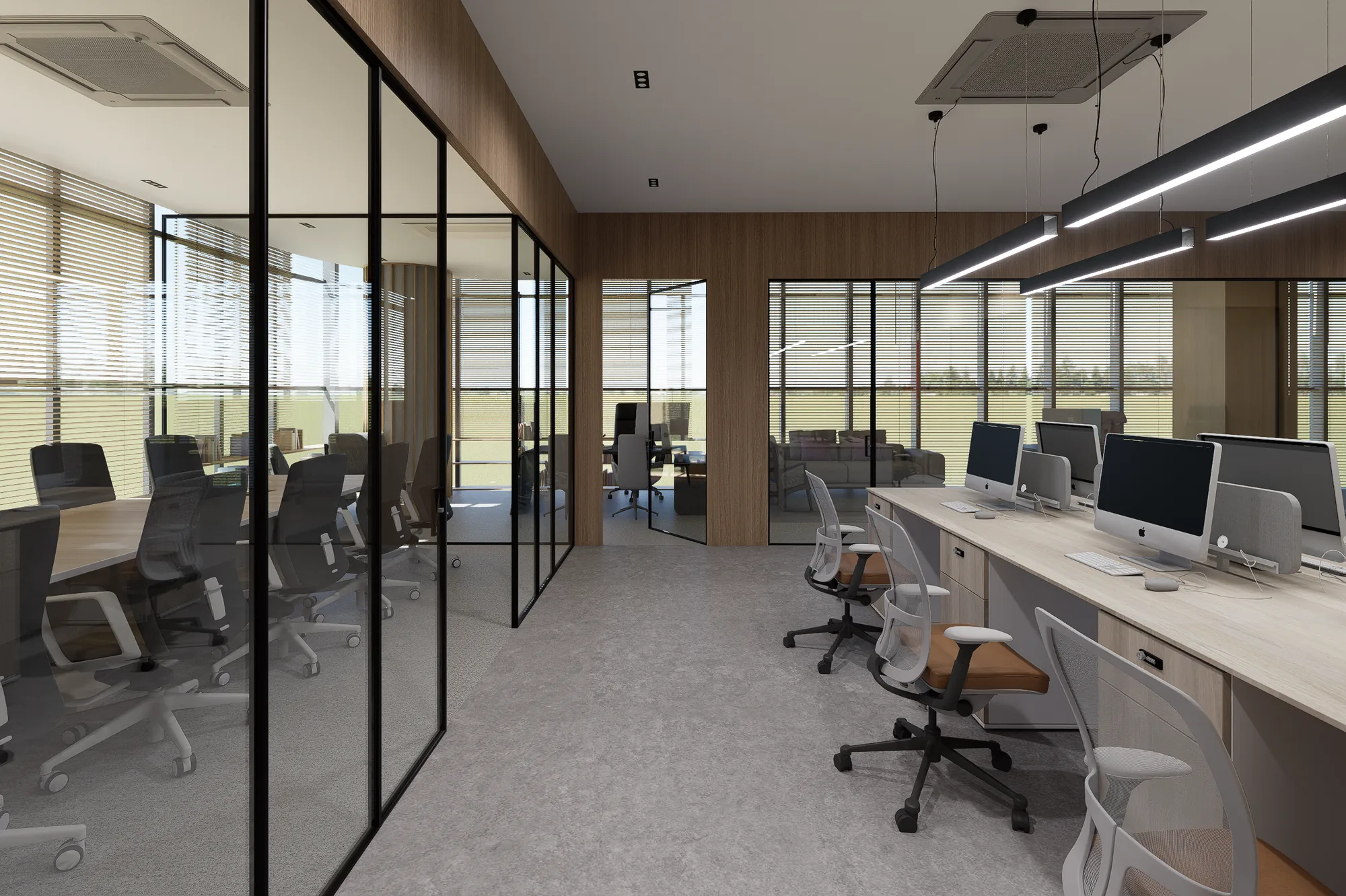 The open-plan floor, glazed cabins on one side and a run of desks on the other